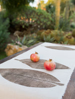 Decoration for the table using handmade tablecloth with antique botanical technique of handmade printed plants directly into the natural fabric.